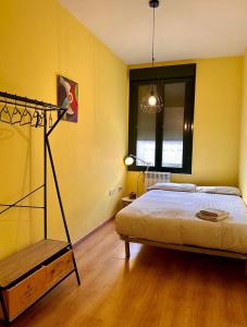 a bedroom with a bed in a yellow wall at Estancia en Bernuy SEGOVIA VUT-40-808 in Bernúy de Porreros