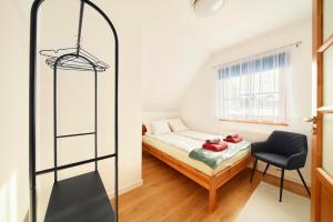 Un pequeño dormitorio con una cama y una silla. en Domki pod Tatrami, en Zakopane