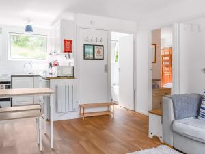 eine Küche und ein Wohnzimmer mit einer Couch und einem Tisch in der Unterkunft 5 The Glade in Bude