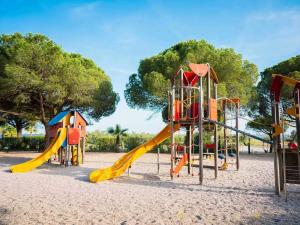 a playground with a slide in the sand at GK - Elégance & Confort, 3ch, 2sdb, piscine, plages et campagne in Lattes