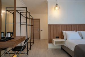 a hotel room with a bed and a desk and a bed and a desk at Ola Hotel in Antalya +10 photos