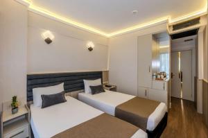 a hotel room with two beds in a room at Nexus By Taksim Hotel in Istanbul