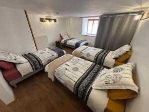 eine Gruppe von 4 Betten in einem Zimmer in der Unterkunft Le Ranch Des Ours in Champagnac-la-Rivière