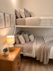 a bedroom with bunk beds with a couch and a table at Hotel Sternen in Gurtnellen