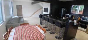 a living room with a table and a couch at Sobrado de 3 quartos in Capão da Canoa