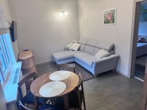 a living room with a couch and a table at Saulgrieži 7 in Ventspils