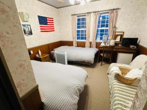 Ένα ή περισσότερα κρεβάτια σε δωμάτιο στο Echoland Madarao エコーランド斑尾 All en-suite rooms & a free 3-minute shuttle to the ski resort