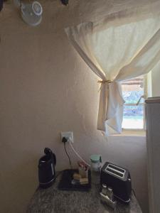 a kitchen counter with a toaster and a window at Loubad Guest Farm in Modimolle