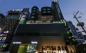 a group of tall buildings in a city at night at 천안 호텔 하루 in Tujŏng-dong