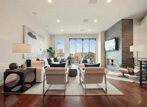 a living room with a couch and chairs and a fireplace at Elegant Three-Bedroom Beachfront Home With Wide Ocean Views in Redondo Beach