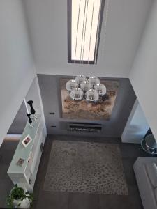 a room with a chandelier and a painting on the ceiling at Villa Corni in La Zubia