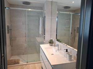 a bathroom with a shower and a sink and a shower at Villa Corni in La Zubia