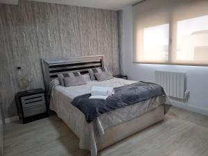 a bedroom with a large bed with two towels on it at Villa Corni in La Zubia