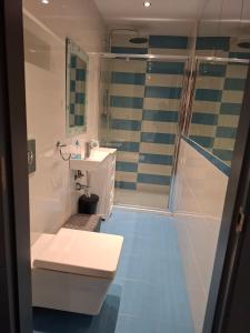 a bathroom with a toilet and a sink and a shower at Villa Corni in La Zubia