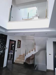 a living room with a staircase with a window at Villa Corni in La Zubia +20 photos