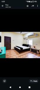 a picture of a bedroom with a bed and a desk at Hotel RR palace iyyapanthangal near Ramachandra hospital in Chennai