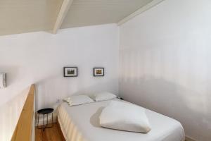 Casa das Pipas Palmela #6 في بينهال نوفو: غرفة نوم بها سرير أبيض كبير مع وسادتين