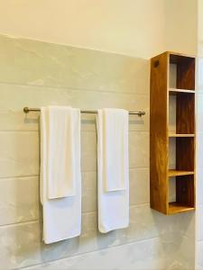 two towels hanging on a towel rack in a bathroom at Crossing Royal in Mirissa +37 photos