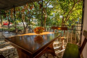 a wooden table with a bowl of fruit on it at Apartamenty U Dragana in Kaštela
