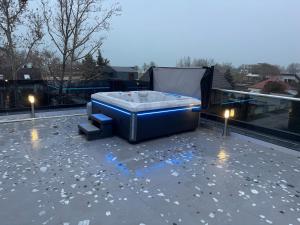 a hot tub sitting on top of a roof at Keszeg Villa Zamárdi in Zamárdi