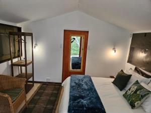 a bedroom with a bed and a ladder and a window at The Lineage Lodge in Elgin