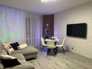 a living room with a christmas tree and a table at Garden Lake Apartment in Peschiera del Garda +20 photos