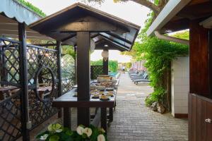 a table with plates of food on it on a patio at Hotel Viña del Mar Pineta in Lido di Jesolo