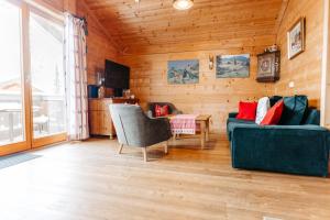 a living room with two couches and a table at Primus Lodge Obertauern in Obertauern