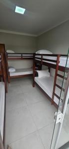 una stanza del dormitorio con tre letti a castello di Apartamento 2 quartos c/ ar-condicionado e garagem a Indaiatuba