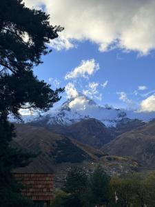 a view of a snow covered mountain in a valley at ADRESATI Stepantsminda in Stepantsminda