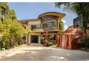 a large house with a large building at OYO 1187 Rose And Ross Place Budget Hotel And Private Resort in Kabaong