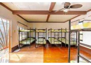 a group of bunk beds in a room with a ceiling at OYO 1187 Rose And Ross Place Budget Hotel And Private Resort in Kabaong