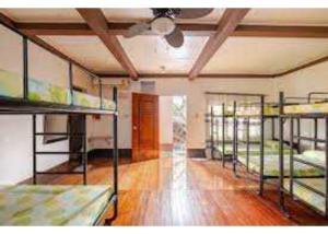 a room with several bunk beds in it at OYO 1187 Rose And Ross Place Budget Hotel And Private Resort in Kabaong