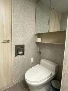a small bathroom with a toilet and a cabinet at 속초 오션뷰 써밋베이1205 in Sajin +12 photos