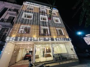 a building with christmas lights on the side of it at Sitara Economy The Pacific, Haridwar in Haridwār