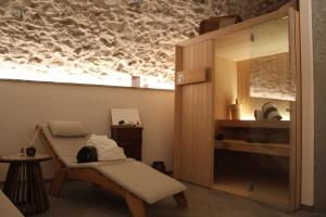 a room with a table and a chair and a shelf at Twinssuites - Adults friendly in Limone sul Garda