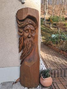 Eine Holzstatue eines Mannes mit Bart an einer Wand in der Unterkunft Haus zur Sonne in Flöha