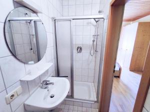 a white bathroom with a sink and a shower at HERRNMÜHLE - Pension & Ferienwohnungen in Rothenburg ob der Tauber +46 photos