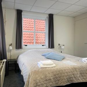 ein Schlafzimmer mit einem Bett mit zwei Handtüchern darauf in der Unterkunft Hotel Willemstad in Willemstad