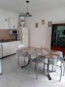 a kitchen with a table and chairs and a refrigerator at Dpto céntrico cómodo in Miramar