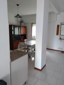 a kitchen and dining room with a table and a table at Dpto céntrico cómodo in Miramar