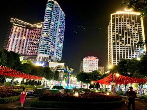 a city skyline with tall buildings at night at Central Halong Hotel in Ha Long