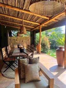 a patio with a table and chairs under a roof at Marini Ndoto in Themi