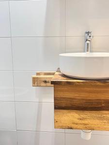 a white bathroom with a sink on a wooden counter at Marini Ndoto in Themi +21 photos