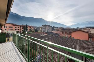 a balcony with a view of a city and mountains at La dimora del Lago in Colico