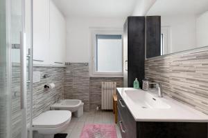 a white bathroom with a sink and a toilet at La dimora del Lago in Colico +20 photos