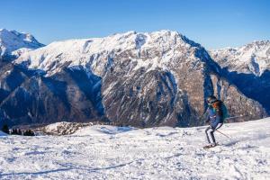 a person on skis standing on a snow covered mountain at Demeure Sauvage - Étage 1 in Villard-Reculas