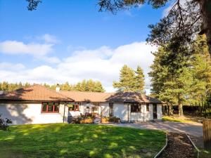una casa bianca con cortile di Woodland House a Tomatin
