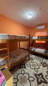 a room with three bunk beds and a carpet at Casa con Piscina Privada in Salinas