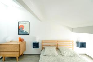 a bedroom with two beds and a wooden dresser at Charmante maison à 200m de la plage in Hossegor